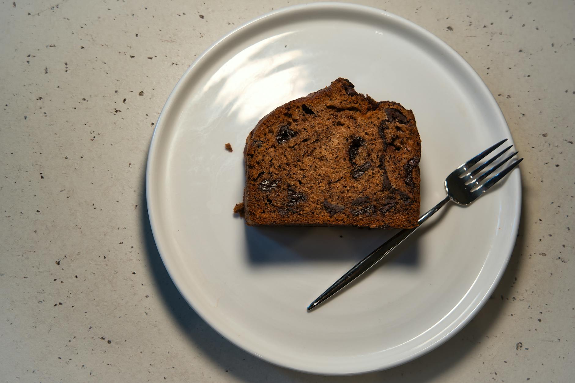 chocolate chip cake slice on white plate